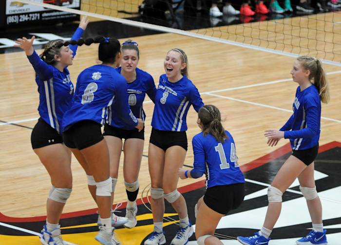 Barron Collier's Chloe Goldenbaum (3) and Ava Kramer (far right) celebrate their block against Jensen Beach.